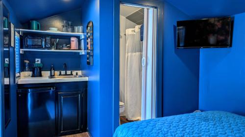 a blue room with a sink and a bathroom at Ocean View Terrace in Hampton Bays