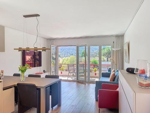 a kitchen and living room with a table and chairs at Apartment Caslago by Interhome in Caslano