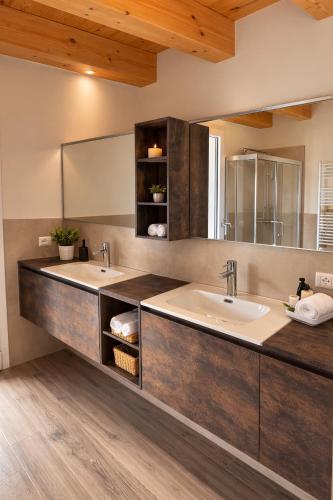 a bathroom with two sinks and a large mirror at Villa Alberti - Elegant, Spacious & Bright Villa in Casa Reali