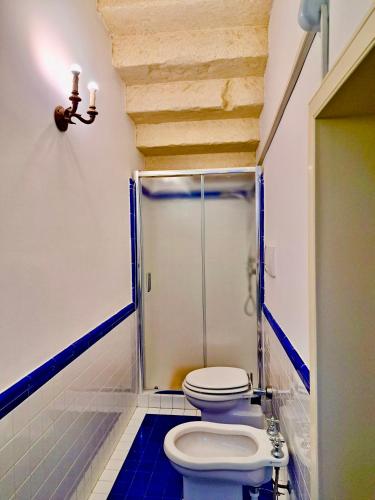 a bathroom with a toilet and a glass shower at Suite Verdi suite room in Lecce