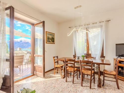 a dining room with a table and chairs and a balcony at Apartment Onda Blu by Interhome in Gera Lario