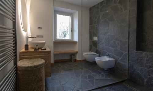 a bathroom with a toilet and a sink and a shower at La casa del lupo in Colico