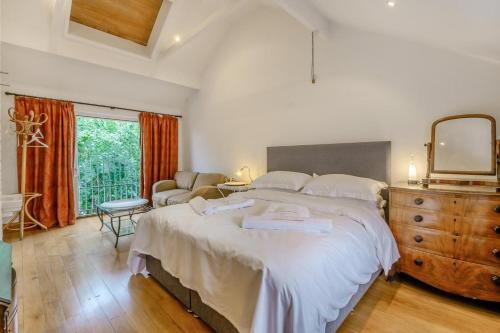 a bedroom with a bed and a dresser and a mirror at 4 Bed in Helmsley oc-y039 in Helmsley
