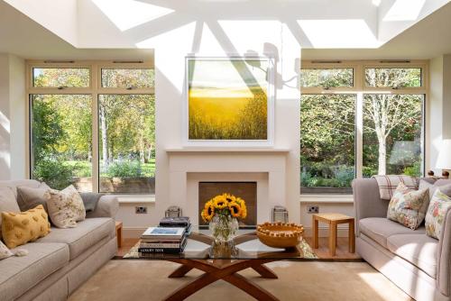 a living room with a couch and a fireplace at The Old Mill House Experience in Dalkeith