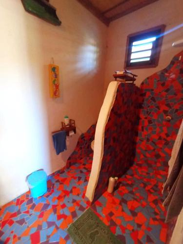 a bedroom with a lego bed with red and blue at Pousada Kite Guajiru in Itarema