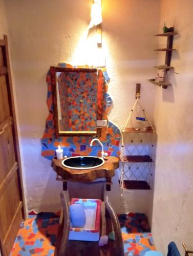 a bathroom with a sink and a mirror at Pousada Kite Guajiru in Itarema