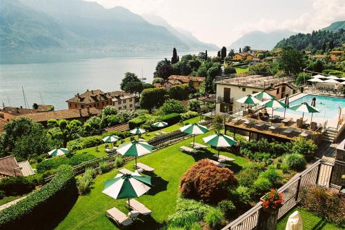 a resort with a lawn with umbrellas and a pool at Belvedere Bellagio in Bellagio