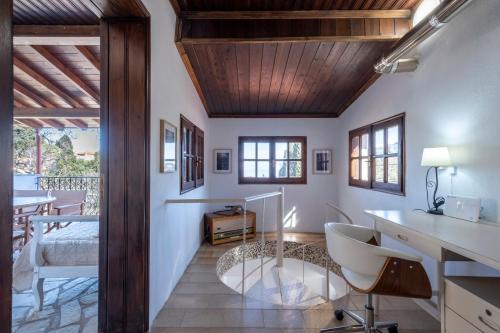 a room with white walls and a wooden ceiling at Guest House Sklithro in Sklíthron