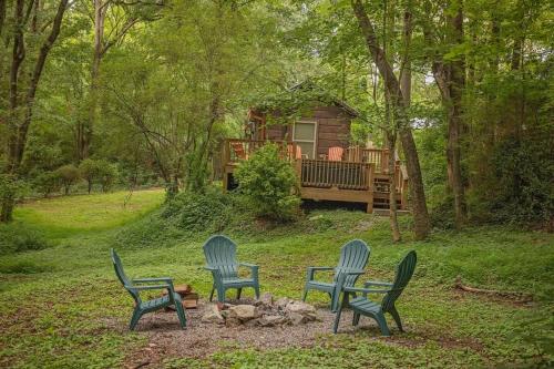 three chairs and a fire pit in front of a cabin at Gabriele Cabin Rustic Retreat Near Downtown in Chattanooga