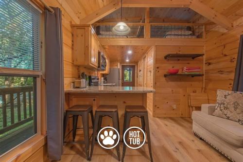 a log cabin kitchen and living room with a couch at Gabriele Cabin Rustic Retreat Near Downtown in Chattanooga