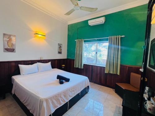 a bedroom with a bed and a window at Leaf Boutique SR in Siem Reap