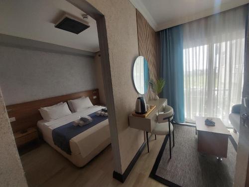 a hotel room with a bed and a mirror at dolunaydın hotel in Side