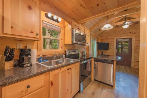 a kitchen with wooden cabinets and a counter top at Apollonie Cabin Lookout Mountain Hot Tub in Chattanooga
