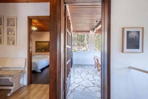 a hallway leading to a bedroom with a bed at Guest House Sklithro in Sklíthron