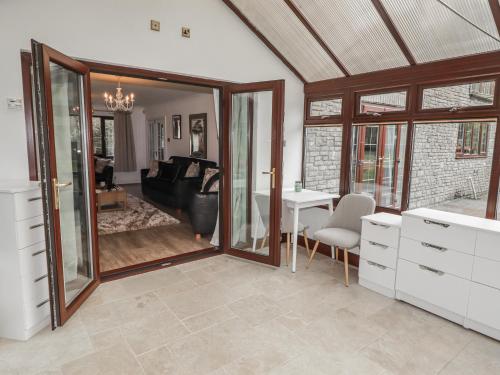 a living room with a desk and a dining room at Willows Lodge at Carreg Llwyd in Cardiff