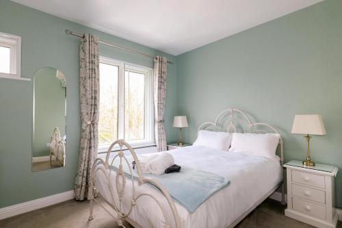 a bedroom with a white bed and a window at Sea Mist Guesthouse in Galway