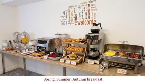 a bakery counter with pastries and other food items on it at Tintagel Arms Bed and Breakfast in Tintagel
