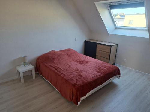 a bedroom with a bed and a dresser and a window at Maison Du Bonheur in Erquy
