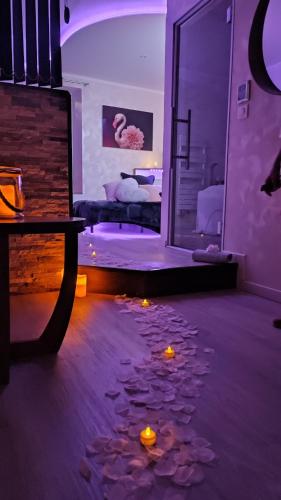 a room with candles on the floor and a bedroom at Suite hors du temps in Le Castellet