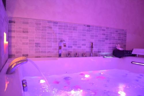 a bathroom with a large bath tub with purple lighting at Suite hors du temps in Le Castellet
