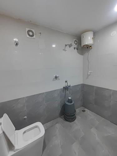 a bathroom with a toilet and a sink at Hotel Elite Walker Town in Hyderabad