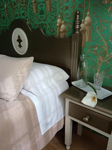 a bedroom with a bed and a table with a night stand at Alojamiento Playa de Candás in Candás
