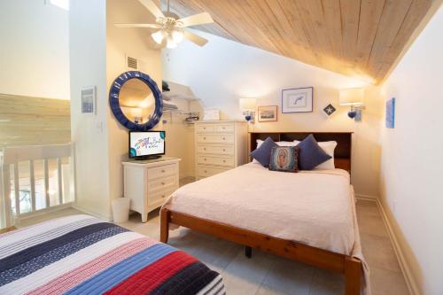 a bedroom with a bed and a ceiling fan at 611 Magnolia-Stella Maris in Edisto Island