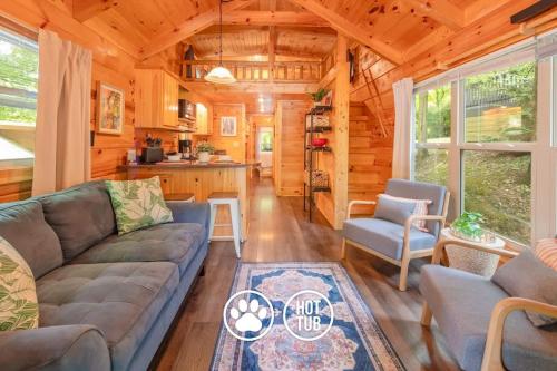 a living room with a couch and a kitchen at Ani Cabin Tiny Home Bordered By National Forest in Chattanooga