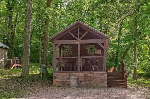 a gazebo with a grill in the woods at Lena Cabin Wooded Tiny Cabin - Hot Tub in Chattanooga