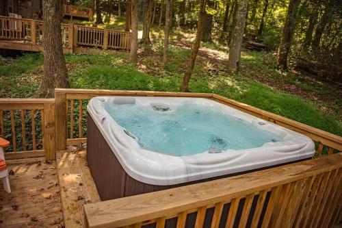 a hot tub on a deck in the woods at Lena Cabin Wooded Tiny Cabin - Hot Tub in Chattanooga