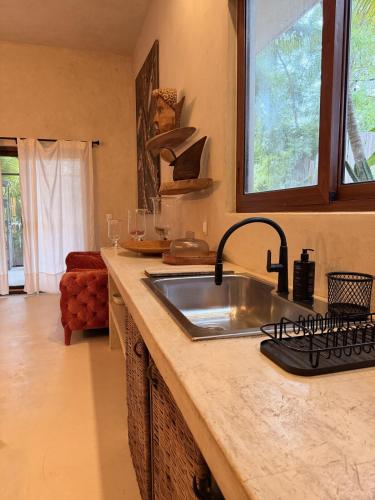 a kitchen with a sink and a counter top at Casa Nikau Chic Getaway in El Cuyo in El Cuyo