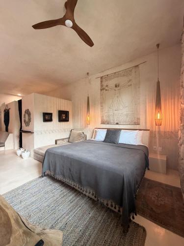 a bedroom with a bed and a ceiling fan at Casa Nikau Chic Getaway in El Cuyo in El Cuyo