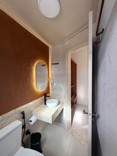 a bathroom with a toilet and a sink at Pumma Hotel Ourilândia in Ourilândia do Norte