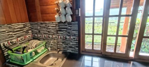 a kitchen with a sink and a window at CABAÑA RaNCH OXAPAMPA in Oxapampa