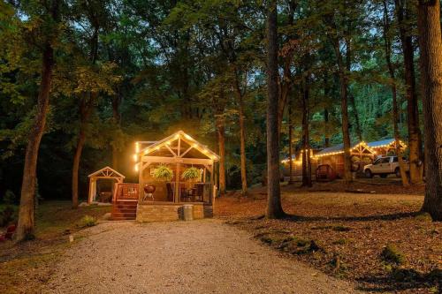 a gazebo with lights in the woods at night at Peggers Cabin Luxury Rustic Tiny Cabin Spa in Chattanooga