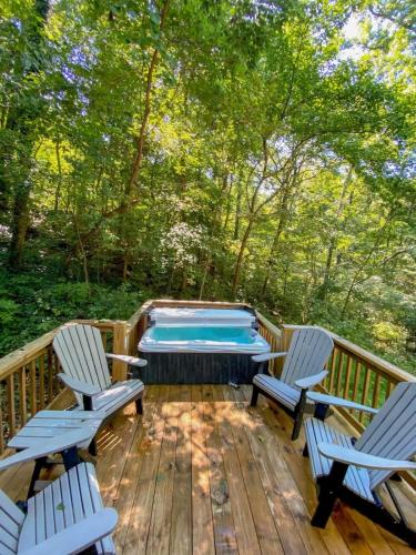 a deck with two chairs and a swimming pool at Nana Cabin Tiny Log Home Comfort In Rustic Bliss in Chattanooga