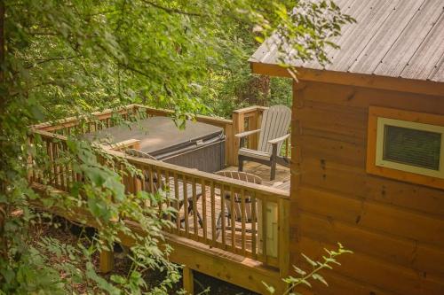 a deck with a chair and a hot tub at Nana Cabin Tiny Log Home Comfort In Rustic Bliss in Chattanooga