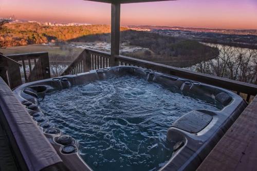 a jacuzzi tub on a deck with a view at Historic Riverview Inn Seven in Chattanooga