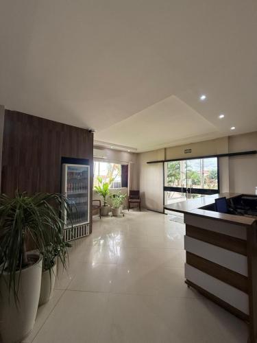 a large kitchen with plants in a large room at Pumma Hotel Ourilândia in Ourilândia do Norte