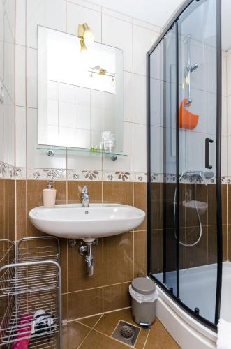 a bathroom with a sink and a shower at Apartments Juka in Milna