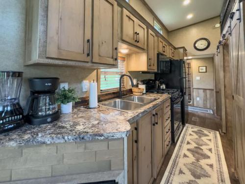 a kitchen with a sink and a counter top at Quail Run Farm- Rustic Tiny Home 3 in Chattanooga