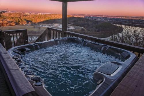 a jacuzzi tub on a deck with a view at Historic Riverview Inn Two in Chattanooga