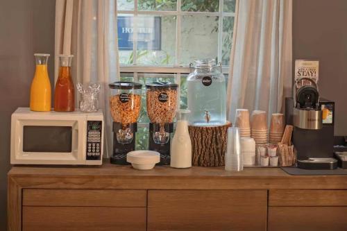 a kitchen counter with a microwave and various items on it at Historic Riverview Inn Two in Chattanooga