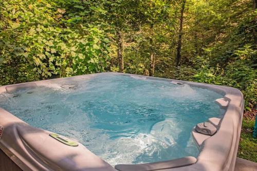 a hot tub in the middle of a forest at Tiny Cabin Village Private Hot Tub Lynda Cabin in Chattanooga