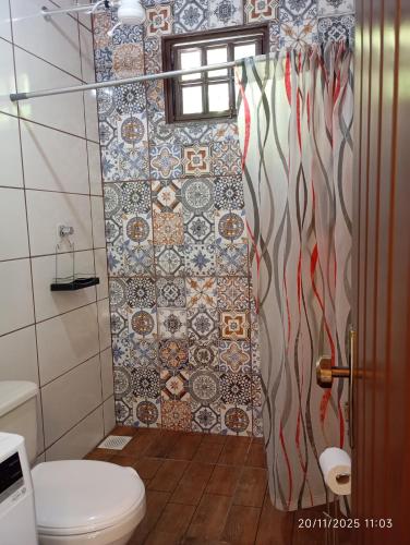 a bathroom with a toilet and a tiled shower at Recanto Gira Cerrado in Cavalcante