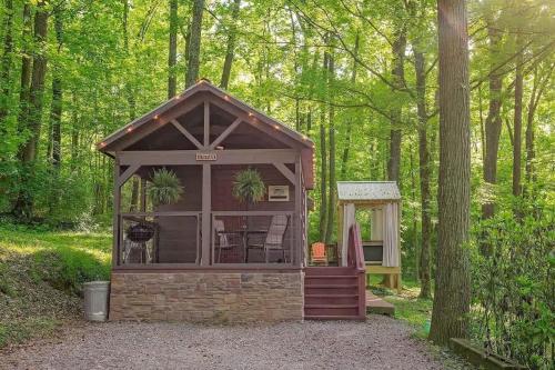 a small building in the middle of a forest at Stefan Cabin Nature-nested Tiny Home Hot Tub in Chattanooga