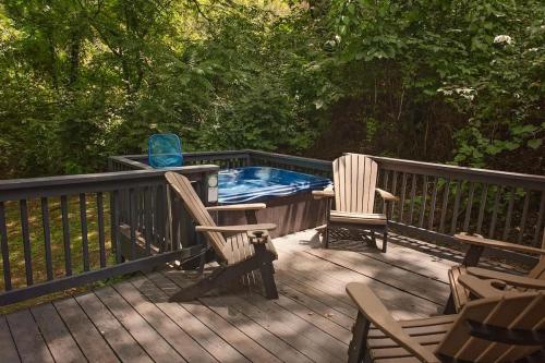 a deck with two chairs and a swimming pool at Elise Cabin Forest Retreat 5 Mins To Downtown in Chattanooga