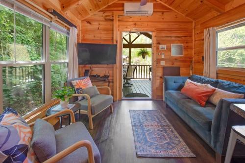 a living room with a blue couch and chairs at Elise Cabin Forest Retreat 5 Mins To Downtown in Chattanooga