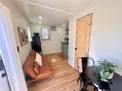 a living room with a couch and a table at Quail Run Farm- Rustic Tiny Home 2 in Chattanooga