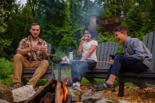 a group of three people sitting around a fire at Historic Riverview Inn Four in Chattanooga